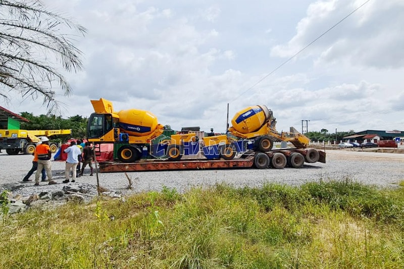 The two self loading concrete mixers are loaded on lowbed for transporting to another working site.